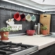 Small modern kitchen with rail system and kitchen utensils and houseplant