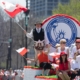 The Polish Constitution Day Parade, Polish man wearing traditional clothing, goral dress waving the polish flag