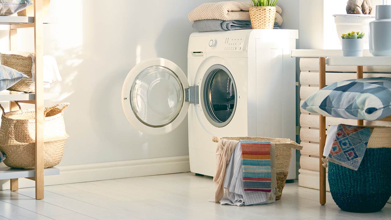 Interior of a real laundry room with a washing machine at home